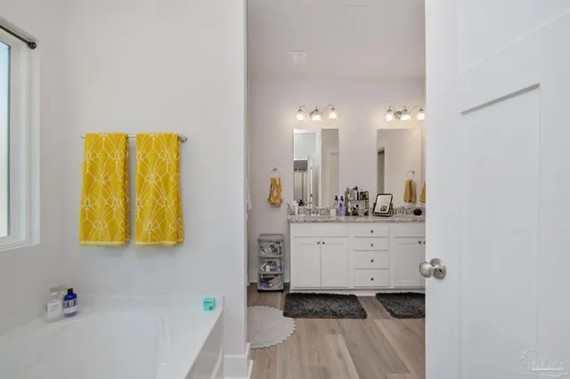 a bathroom with a sink mirror and vanity