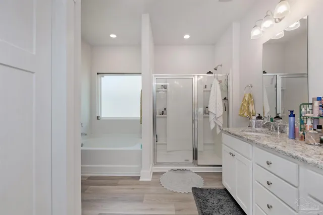 a bathroom with a granite countertop sink mirror and shower