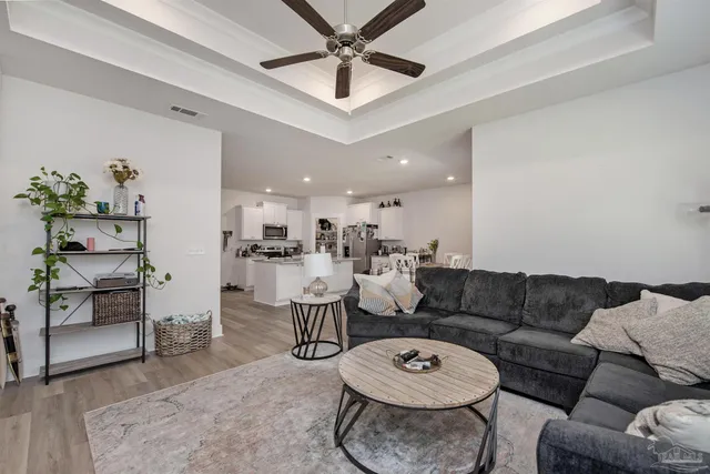 a living room with furniture a rug and a chandelier