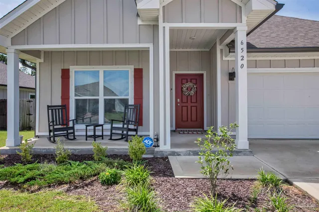 a front view of the house with chairs
