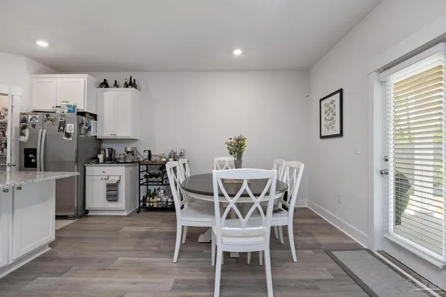 a view of a dining room with furniture and window