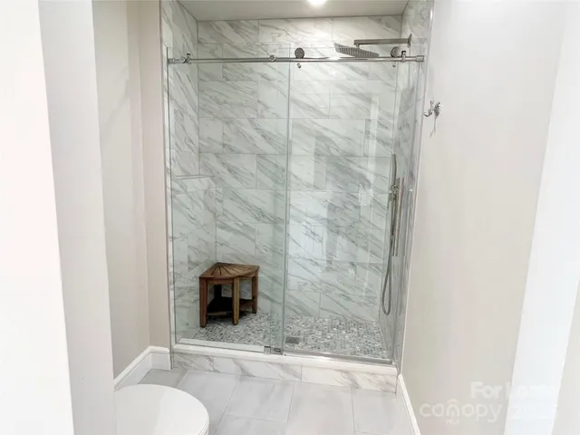 a bathroom with a toilet and a shower