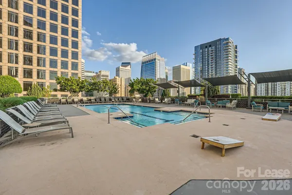 a living room with furniture a flat screen tv and a floor to ceiling window