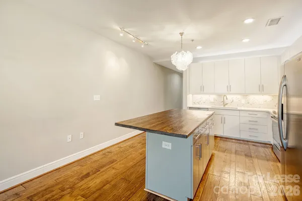 a kitchen with stainless steel appliances granite countertop a sink a stove and a refrigerator