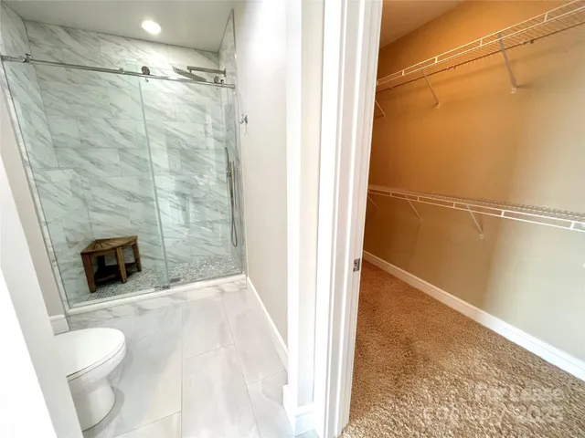 a bathroom with a toilet and a shower