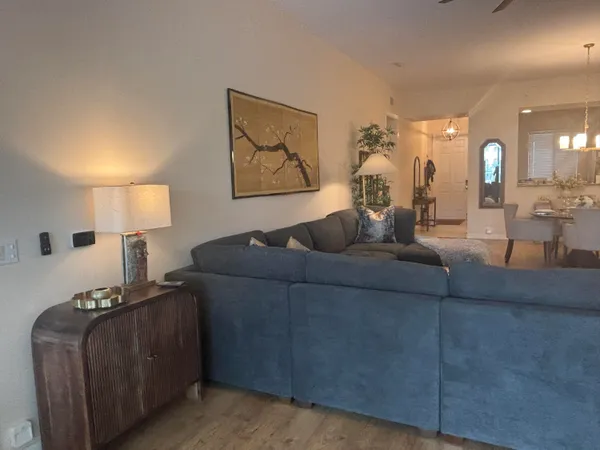 a living room with furniture and a lamp