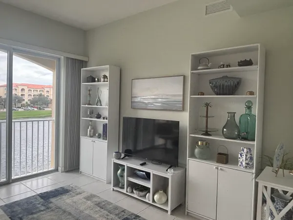 a living room with a flat screen tv and a window