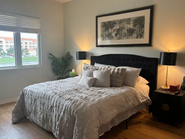 a bed sitting in a bedroom next to a window