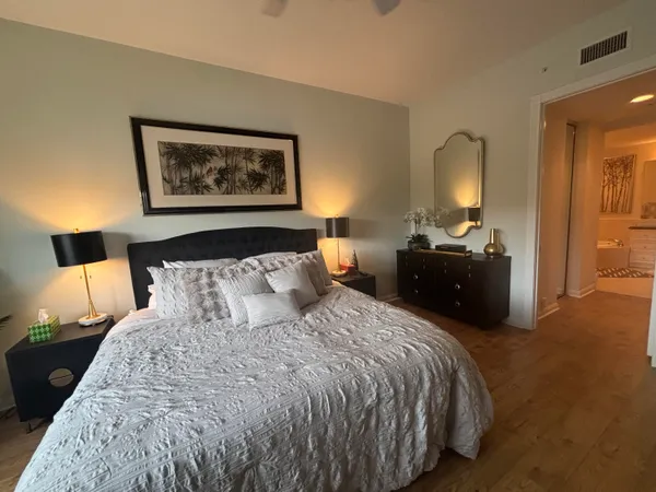 a bed room with a bed and a painting