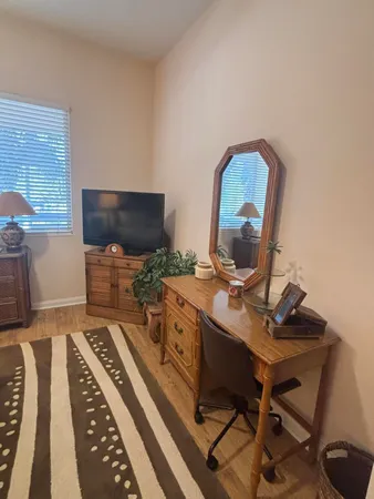 a room with a chair and a flat screen tv
