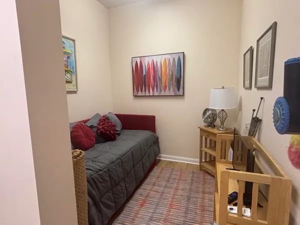 a living room with furniture and a wooden floor