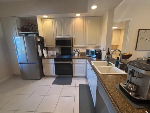 a kitchen with a sink appliances and cabinets