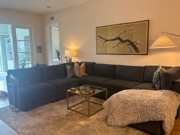 a living room with a couch and a painting on the wall