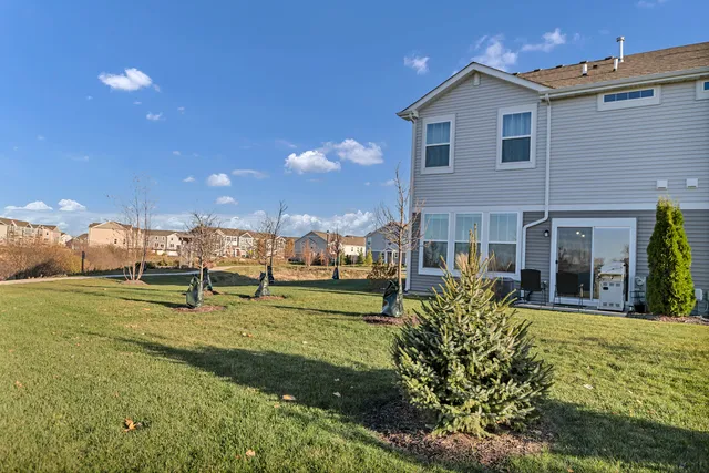 a view of a house with a yard and sitting area