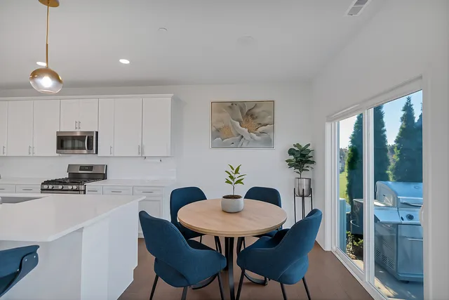 a view of a dining room with furniture and a potted plant