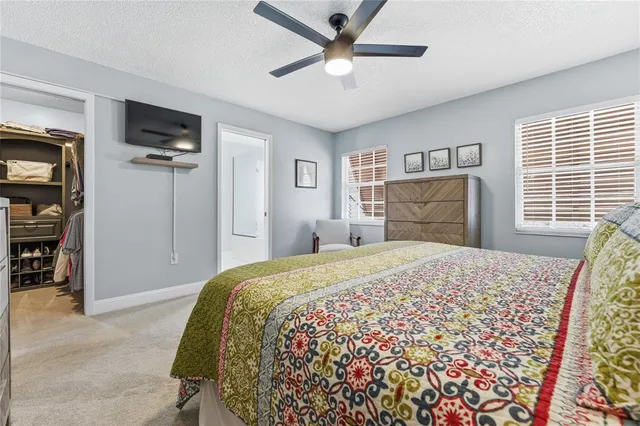 a bedroom with a bed and a television