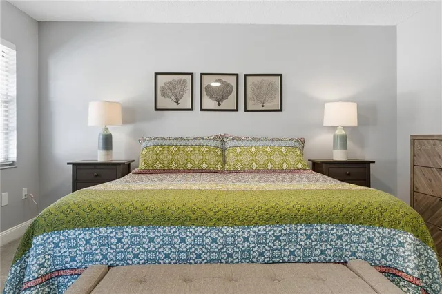 a bedroom with a bed and a lamp