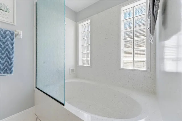 a white bath tub sitting next to a window