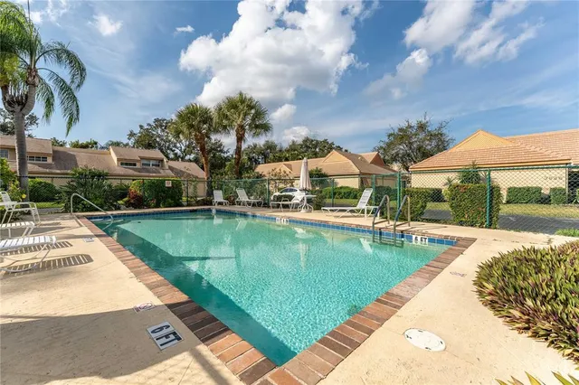 a view of a house with a yard and pathway