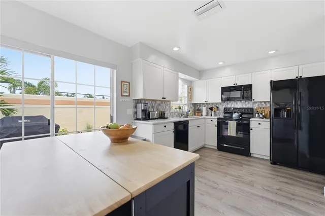 a kitchen with a sink a counter top stainless steel appliances and cabinets