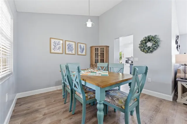 a view of a dining room with furniture and window