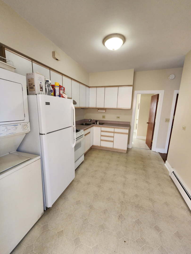 48 Crystal Street, Unit 2F Cary, IL 60013 - Photo 3 of 6 a view of kitchen with refrigerator and microwave