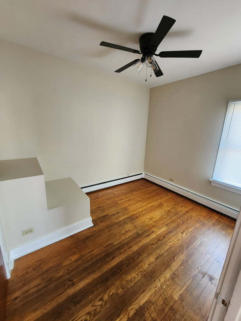 48 Crystal Street, Unit 2F Cary, IL 60013 - Photo 5 of 6 wooden floor in an empty room