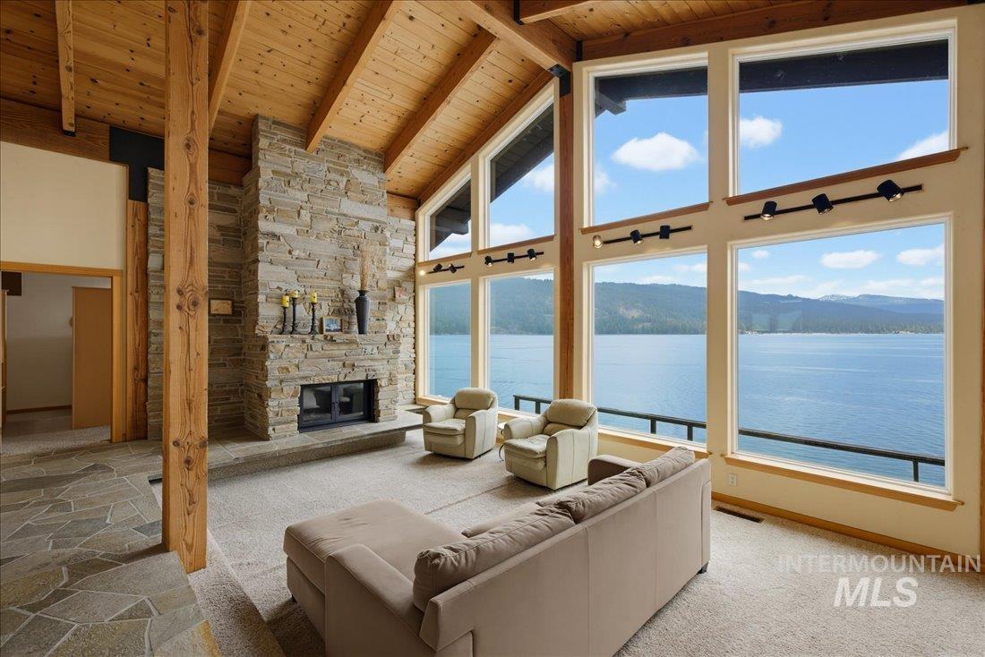 3800 Warren Wagon Road McCall, ID 83638 - Photo 7 of 50 Vaulted wood-paneled ceilings with exposed beams complement the full-height stone fireplace