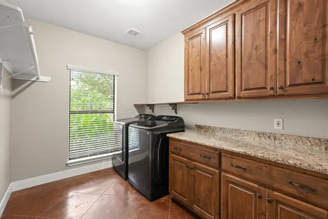 a bathroom with a granite countertop sink a toilet a mirror a bathtub and shower