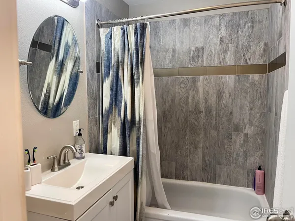 a bathroom with a sink a mirror and a bathtub
