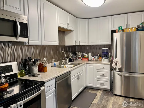a kitchen with a sink stove and refrigerator