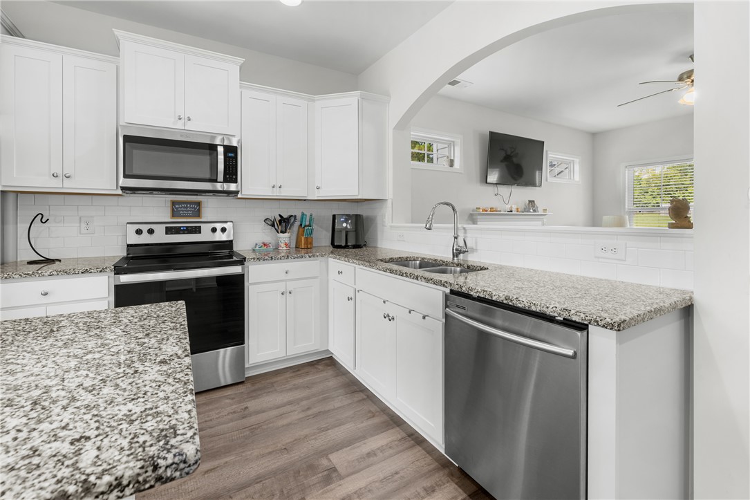768 Rocky Ridge Circle Seneca, SC 29678 - Photo 11 of 30 A well-appointed kitchen features granite counters, stainless steel appliances, and wood-look flooring.
