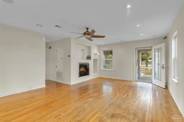 a view of a house with a small yard and wooden fence