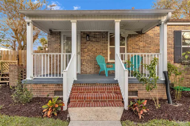 a view of an empty room with wooden floor fireplace and a window
