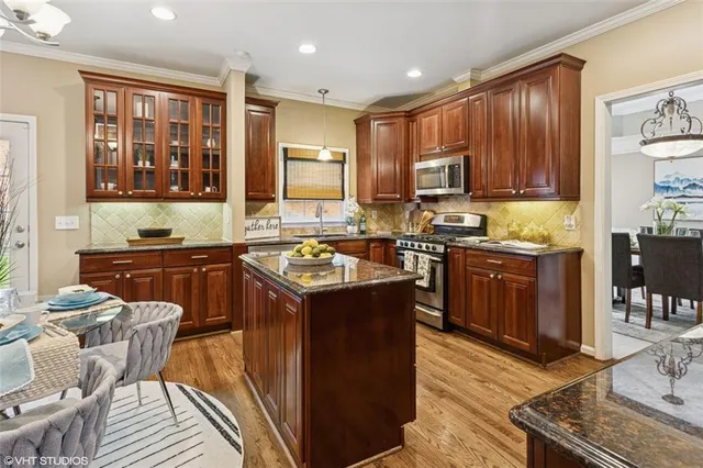 a view of a dining room with furniture a chandelier and wooden floor