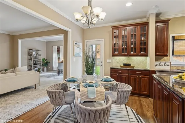 a kitchen with granite countertop lots of wooden cabinets stainless steel appliances