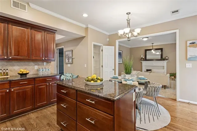 a view of a dining room with furniture wooden floor and chandelier