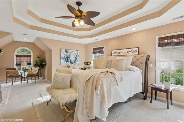 a spacious bedroom with a bed and a chandelier