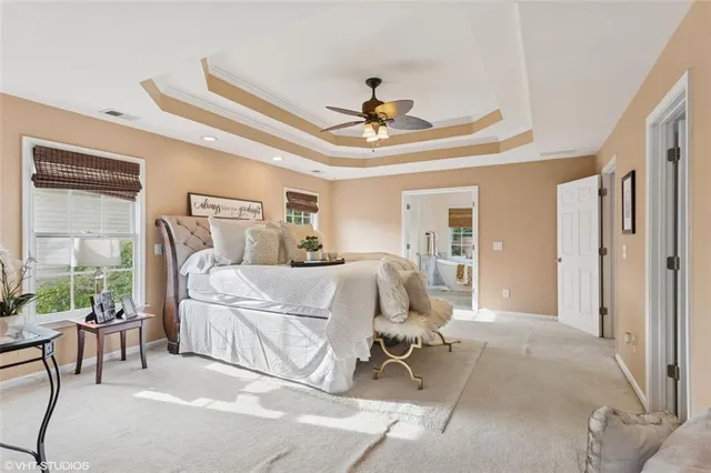 a spacious bathroom with a granite countertop tub shower and mirror
