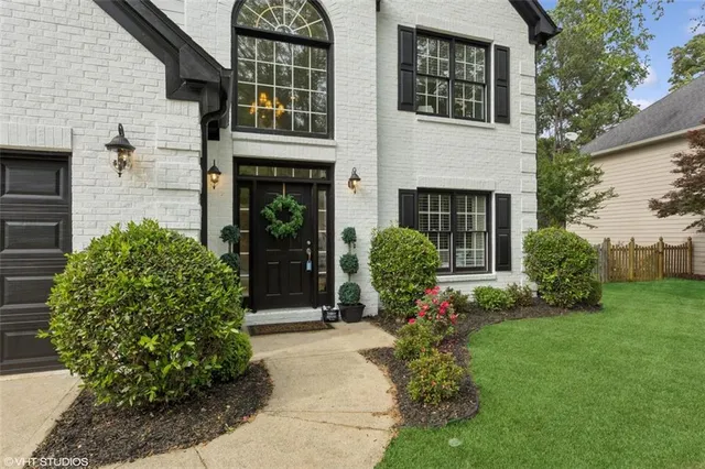 a front view of a house with garden