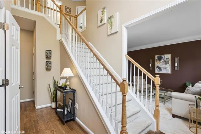 a view of entryway and hall with wooden floor