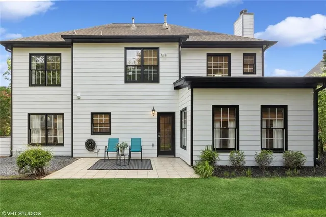 a view of a house with backyard and deck