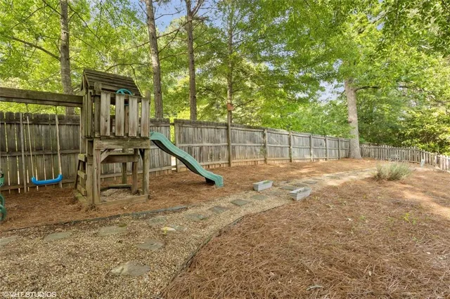 a view of a balcony with floor to ceiling windows and wooden fence
