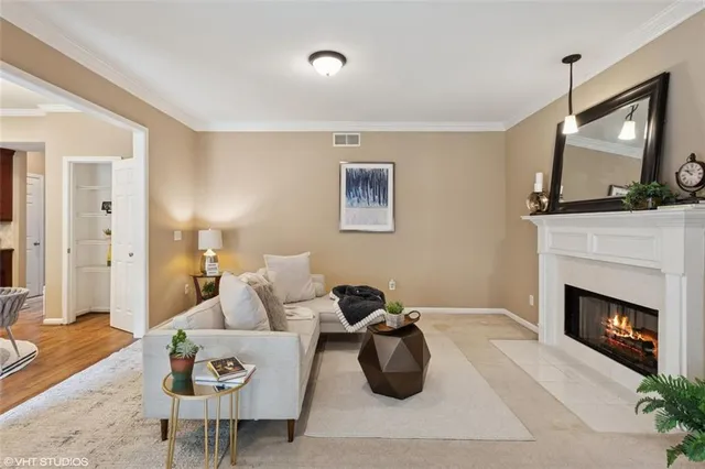 a kitchen with stainless steel appliances granite countertop a stove top oven a sink dishwasher a dining table and chairs with wooden floor