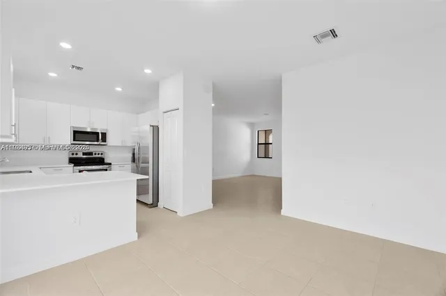 a kitchen with stainless steel appliances a stove sink and microwave