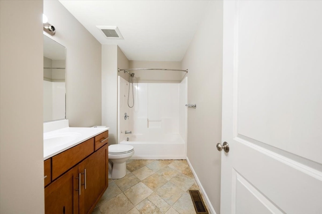 6 Bates Street, Unit A Devens, MA 01434 - Photo 26 of 41 a bathroom with a sink a toilet a mirror and shower