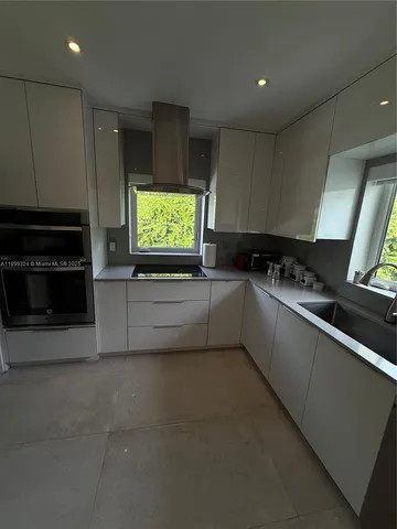 a kitchen with stainless steel appliances a stove a sink and a microwave
