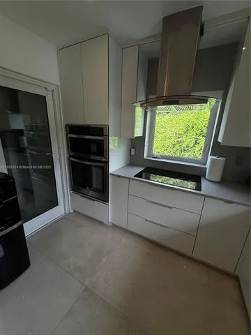 a kitchen with stainless steel appliances a refrigerator and a stove
