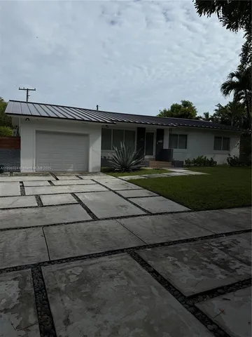 a backyard of a house with yard and garage