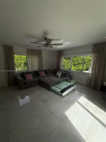 a living room with furniture and a large window